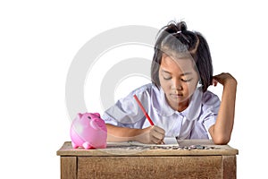 Cute asian country girl Make a note of income receipts and coins with piggy bank isolated on white background
