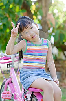 Cute asian girl enjoy to ride bicycle