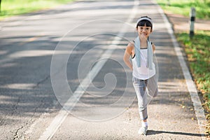 Cute asian girl exercise in gardent background