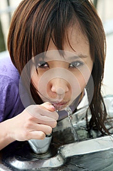 Cute Asian girl having a cool drink