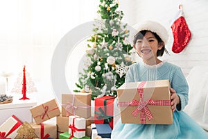 Cute Asian girl holding a Christmas gift box