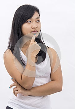 Cute asian girl on isolated background thinking