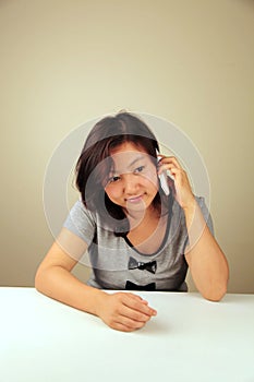 Cute Asian girl making a call