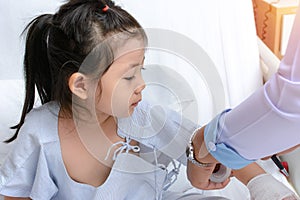 Cute Asian Girl patient looking at wound care nurse with interest