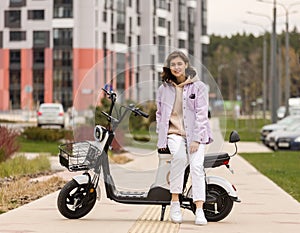cute asian girl rides electric scooter in modern city photo