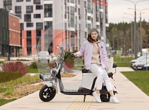 cute asian girl rides electric scooter in modern city photo