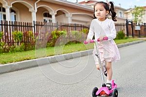 Cute Asian Girl Riding Scooter