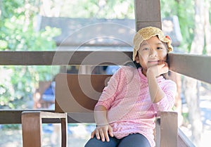Cute asian girl smile and sitting on old chair