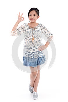 Cute asian girl in summer dress showing ok sign