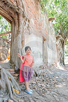 Cute asian girl wear Thai dress at temple location.