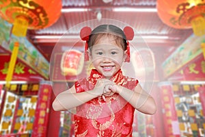 Cute asian kid girl in Traditional Chinese dress at chinese temple in bangkok thailand, Chinese new year concept