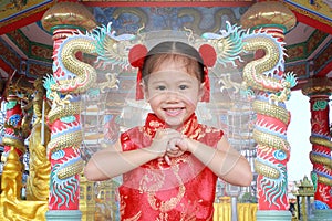 Cute asian kid girl in Traditional Chinese dress at chinese temple in bangkok thailand, Chinese new year concept