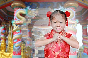 Cute asian kid girl in Traditional Chinese dress at chinese temple in bangkok thailand, Chinese new year concept