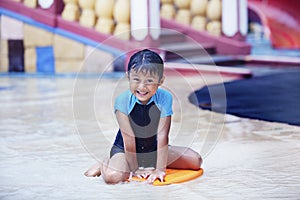 Cute Asian Kid smiling at swimming pool