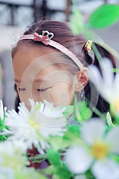 Cute Asian little beautiful girl smell flower