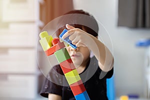 Cute asian little boy playing with colorful toy blocks, Kids play with educational toys at kindergarten or daycare