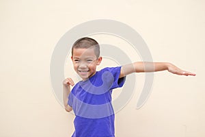Cute asian little boy smiling happily and standing in the studio