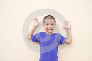 Cute asian little boy smiling happily and standing in the studio