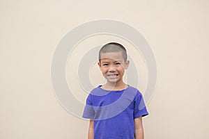 Cute asian little boy smiling happily and standing in the studio