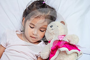 Cute asian little child girl with her teddy bear