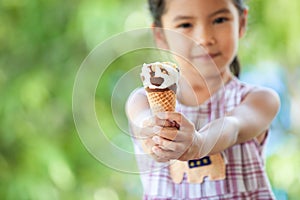 Cute asian little child girl holding delicious icecream cone