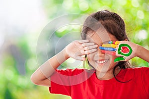 Cute asian little child girl with painted hands smiling