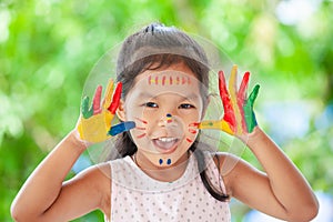 Cute asian little child girl with painted hands smiling