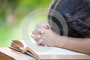 Cute asian little child girl praying with folded her hand