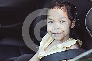 Cute asian little child girl sitting in the car seat