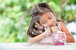 Cute asian little child girl stingy her money photo