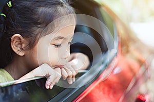 Cute asian little child girl traveling by car