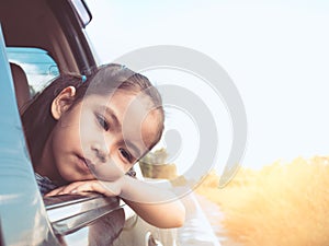 Cute asian little child girl traveling by car