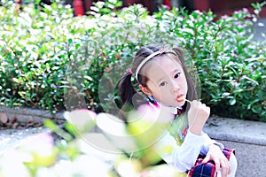 Little girl with lollipop Cute Asian little beautiful girl play at autumn in the city park