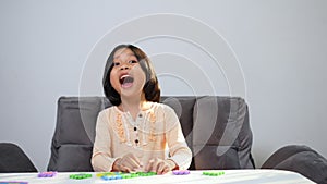 Cute Asian little girl playing with colorful toy ABC jigsaw, Kids play with educational toys at kindergarten or daycare. Creative