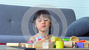 Cute asian little girl playing with colorful toy blocks, Kids play with educational toys at kindergarten or daycare. Creative