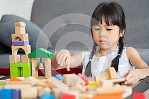 Cute Asian little girl playing with colorful toy blocks, Kids play with educational toys at kindergarten or daycare. The creative