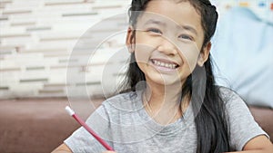 Cute Asian little girl smiling with happiness with copy space composition