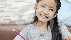 Cute Asian little girl smiling with happiness with copy space composition