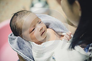 Cute asian newborn baby girl take a bath in bathtub