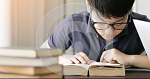 Cute asian teen boy doing your homework at home.