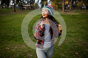 Cute Asian Teen Girl Smilling In Autumn Forest. Candid Woman In Hat Enjoying Autumn In The Forest .