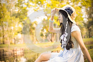 A cute Asian Thai girl is looking in the sky with hope in natural atmosphere