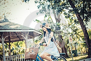 Cute Asian Thai girl in vintage clothings is riding a bicycle, i