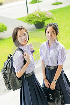 Cute Asian Thai high schoolgirls student couple in school uniform photo