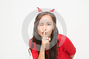 Cute Asian woman making a sign don`t telll something for Christmas and New Year`s Day concept