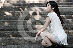 Cute Asian woman in a white top looking away with attitude