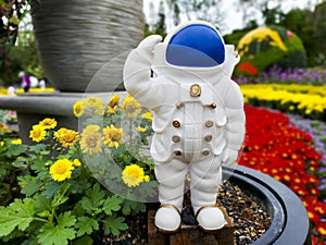 A cute astronaut standing in the garden.