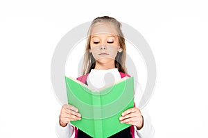 cute, attentive schoolgirl reading book isolated on white.