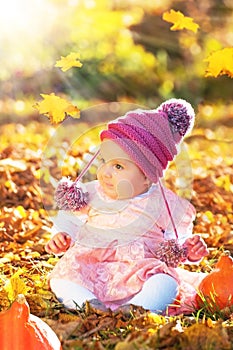 Cute autumn baby girl in golden soft light