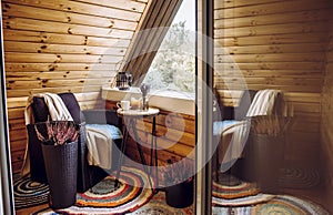 Cute autumn home decor arrangement on wood timber cabin balcony.